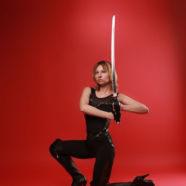 A person holding a strong warrior yoga pose, showing balance and power.